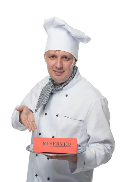 Kuchař ukazuje na rezervu deska — Stock fotografie