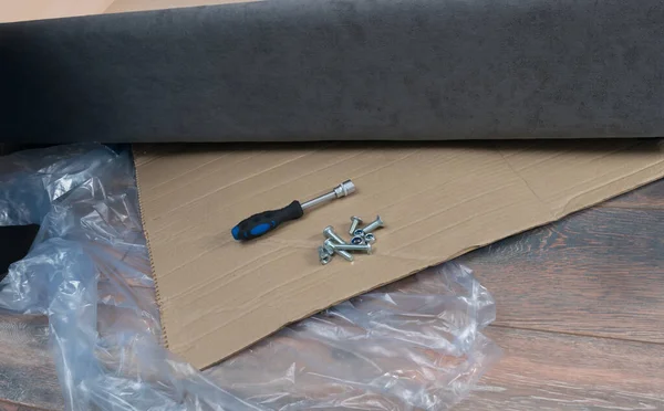 on the packaging materials, cardboard and polyethylene, there are several bolts and a key for assembling upholstered furniture