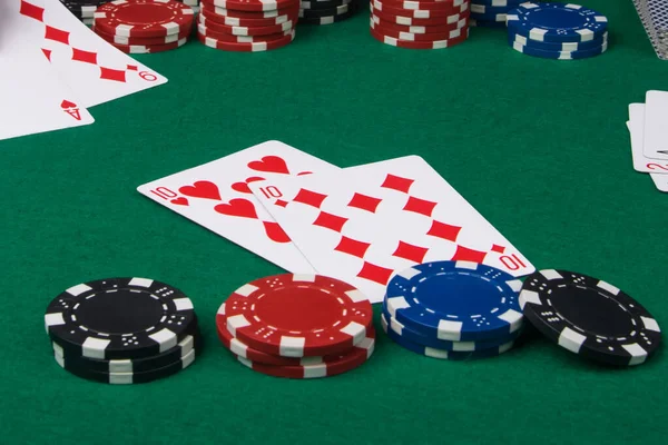 two red cards with high bet of chips in a game of poker
