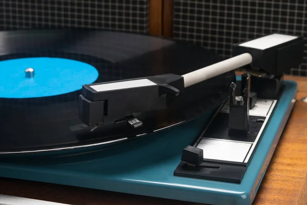 equipment for listening to vinyl records on a brown table, side view