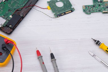 on a light background, a set of tools for repairing and replacing batteries and the smartphone screen