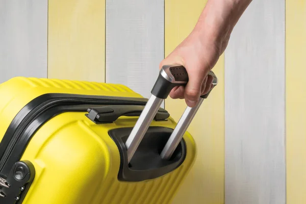 Hand Carries Suitcase Gray Yellow Background Close — Stock Photo, Image