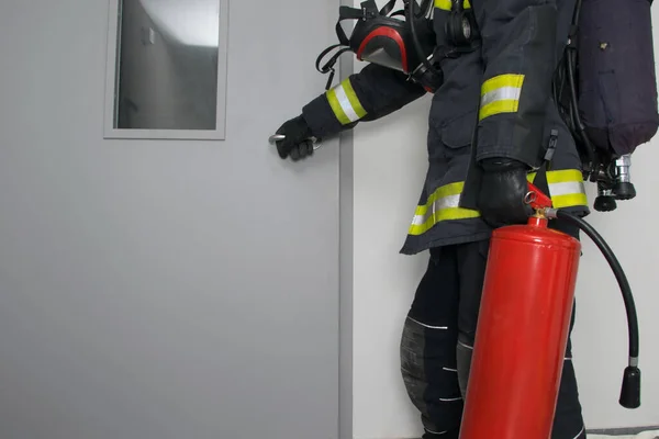 Firefighter Protective Clothing Fire Extinguisher Opens Iron Door Place Inscription — Foto de Stock