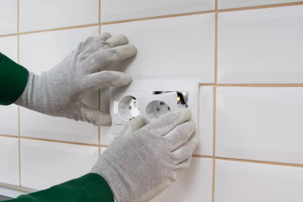 Een Elektricien Installeert Een Stopcontact Een Betegelde Wand — Stockfoto