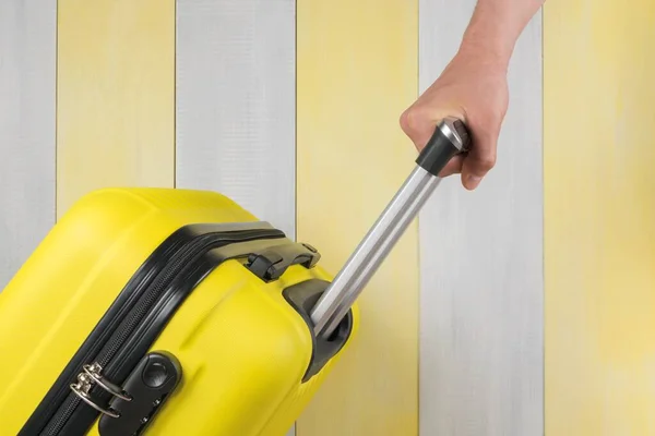 Hand Carries Suitcase Gray Yellow Background Close Side View — Stock Photo, Image