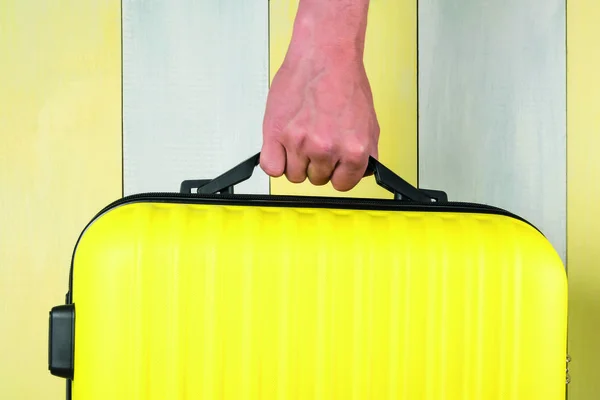 Hand Carries Suitcase Yellow Gray Background Close Travel Concept — Stock Photo, Image