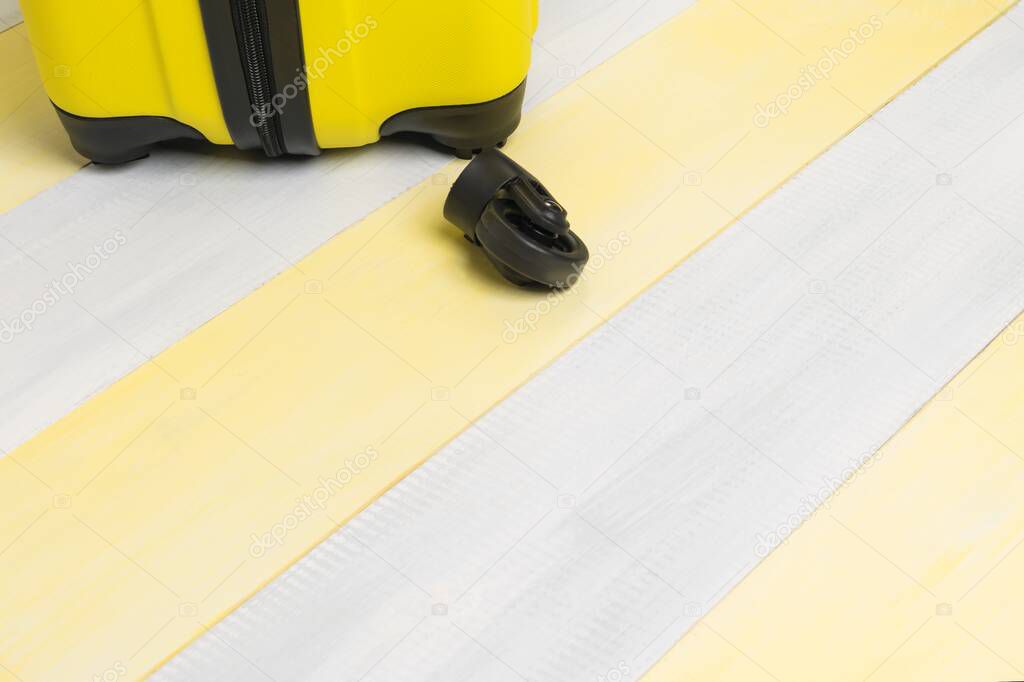 the bottom of a suitcase with broken wheels on the gray yellow floor boards, a place for your lettering