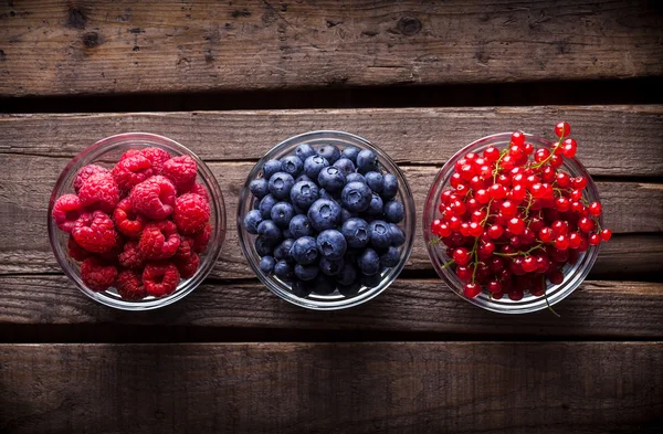 Berries mix in a studio in glass jars