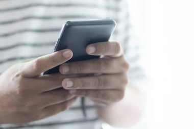 Akıllı telefon kullanarak ve el ele tutuşarak.