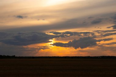Güzel parlak turuncu ve koyu mavi gün batımı bozkırlarda. Karanlık çöktükten sonra ılık sonbahar huzurlu atmosferinde tarım arazisi.