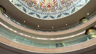 Kemer, Turkey - September 21, 2025 - Ornate stained glass dome ceiling with colorful geometric and floral patterns, viewed from below, featuring a large circular chandelier at the center.