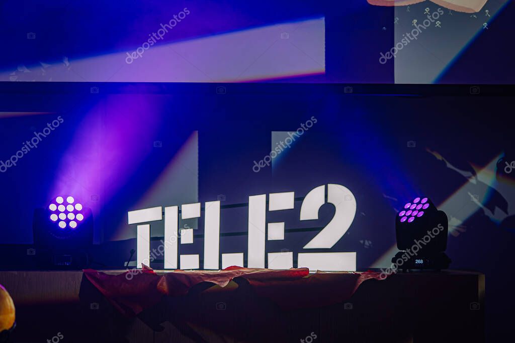 Riga, Latvia - October 24, 2025: Tele2 logo stands out at an event with vibrant lighting and colorful background enhancing the lively ambiance
