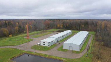 Valka, Letonya - 29 Ekim 2025: Baca ve depolama binalarının yer aldığı sanayi bölgesinin hava perspektifi, kamera tavaları çevredeki manzarayı doğru gösteriyor
