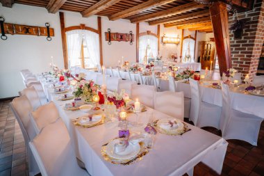 Yemek alanında çiçekler, mumlar ve ince porselenler ile süslenmiş masalar özel durumlar için sıcak bir ortam yaratıyor.