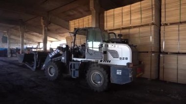 Valmiera, Letonya - 01 Ekim 2025: Operatör manevraları Luyu 928 yükleyici, geniş bir depoda malzeme taşıma, eylem akışı ve tasarım için kopyalama alanı
