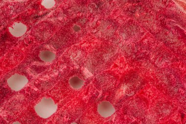 Dondurulmuş çileklerin yakın plan görüntüsü canlı kırmızı bir renk ve belirgin gözenekli bir doku sergiliyor, susuz kalmış meyvelerin doğal güzelliğini ve besleyici faydalarını vurguluyor.