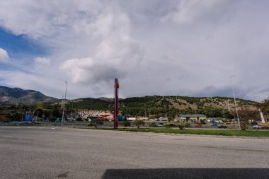 Malaga, İspanya - 13 Mart 2026: Ticari bina ve dağların yer aldığı yol kenarı manzarası, kırsal bir manzara ve altyapı sergilenmektedir