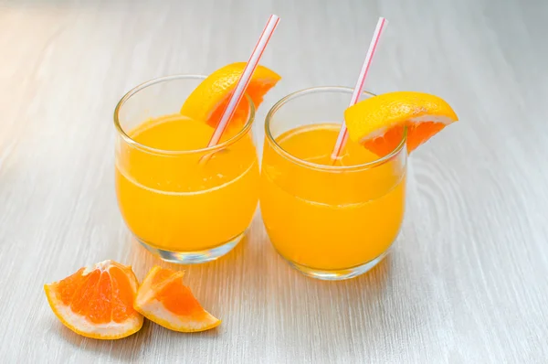Some orange juice with straw into glass for breakfas — Stock Photo, Image
