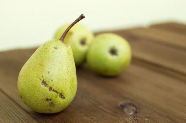 Some yellow pears are on the wooden table — Stock Photo, Image