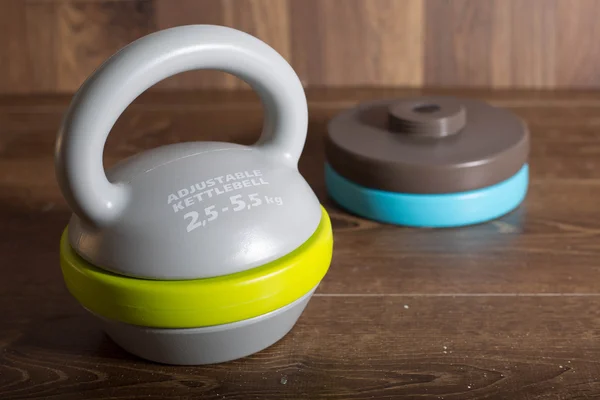 Ahşap arka plan üzerinde ayarlanabilir kettlebell.