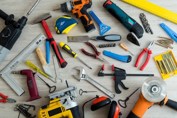 Different tools on a light wooden background — Stock Photo, Image