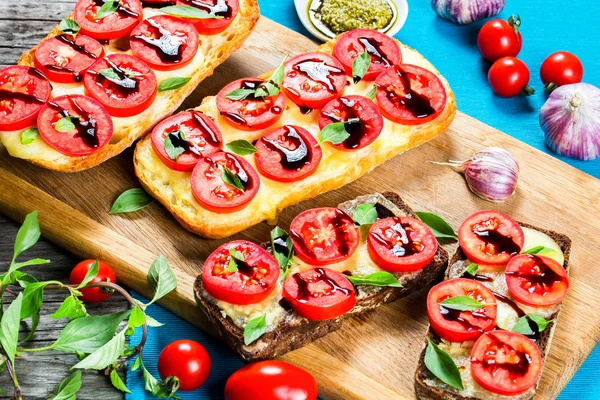 Caprese Garlic Ciabatta hot Bread toasts with mozzarella cheese, tomatoes — Stock Photo, Image