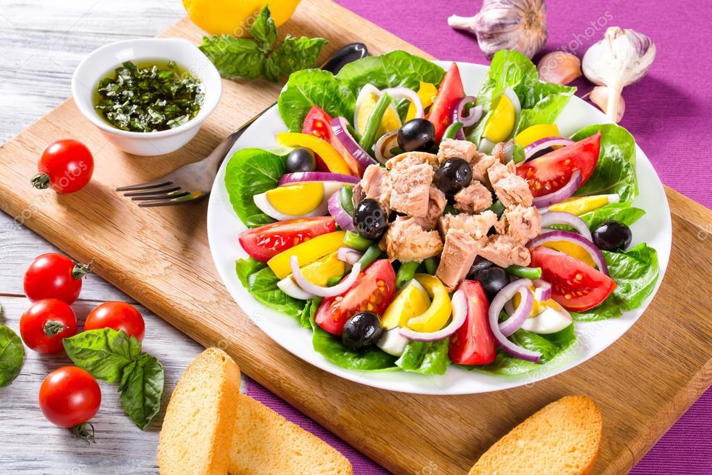 French salad with canned tuna and fresh vegetables and herbs Stock