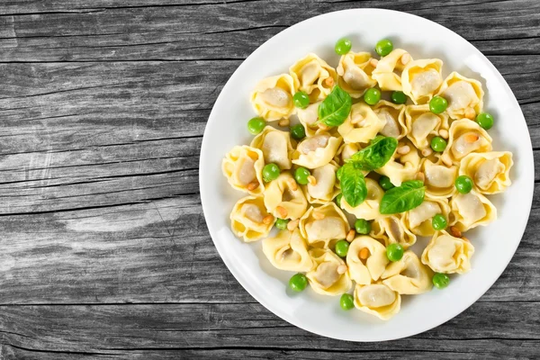 Tortellini with green peas, fried Pine nuts,  top view — Φωτογραφία Αρχείου