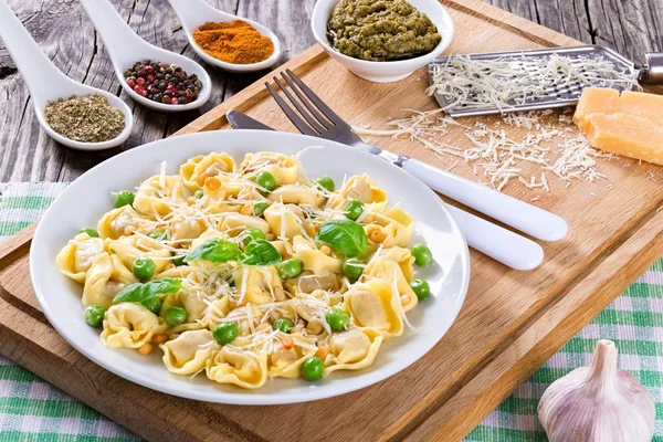 Tortellini with green peas, Pine nuts, parmesan cheese and grater — Stock Photo, Image