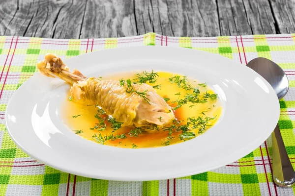 Soup with carrot and chicken leg decorated with dill — Stock Image Soup with carrot and chicken leg decorated with dill Stock Photo