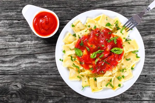 Italian ravioli with tomato sauce, top view — Stock Photo, Image