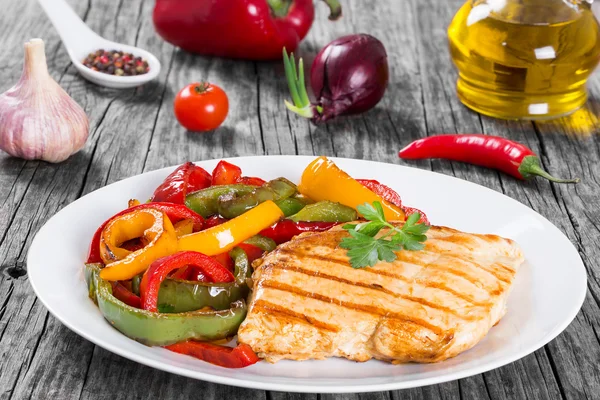 Gegrilde Kipfilet kipfilet en gebakken paprika, clos-up — Stockfoto