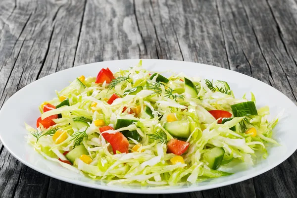 stock image spring cabbage salad with bell pepper, corn and dill, close-up