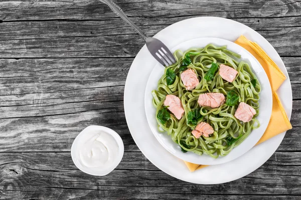 Salmon and Spinach Fettuccine pasta on white dishes