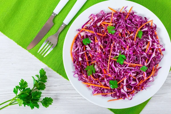 Red cabbage salad with carrots and parsley on white dish — Stock Image Red cabbage salad with carrots and parsley on white dish Royalty Free Stock Images
