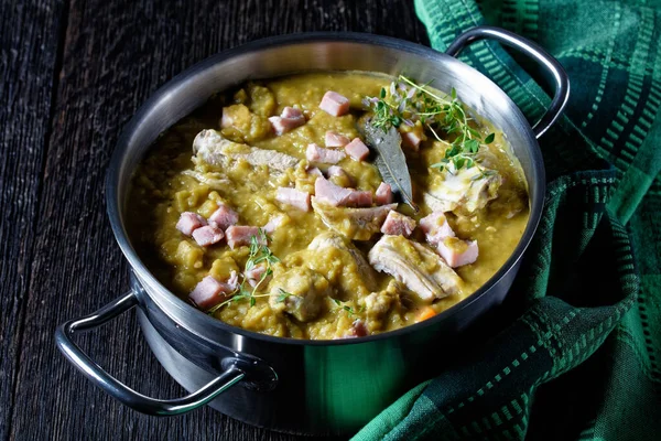 Green peas finnish soup with pork ribs and ham in a pot, horizontal view from above, close-up — Stock Image Green Peas Finnish Soup Pork Ribs Ham Pot Horizontal View Royalty Free Stock Photos