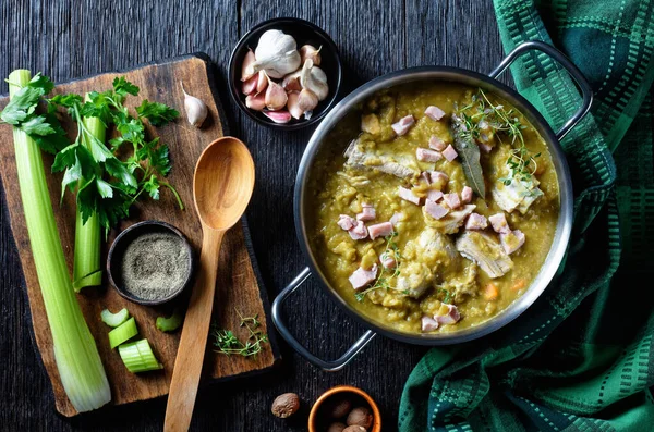 Green peas finnish soup with pork ribs and ham in a pot, horizontal view from above, flat lay — Stock Image Green Peas Finnish Soup Pork Ribs Ham Pot Horizontal View Royalty Free Stock Images