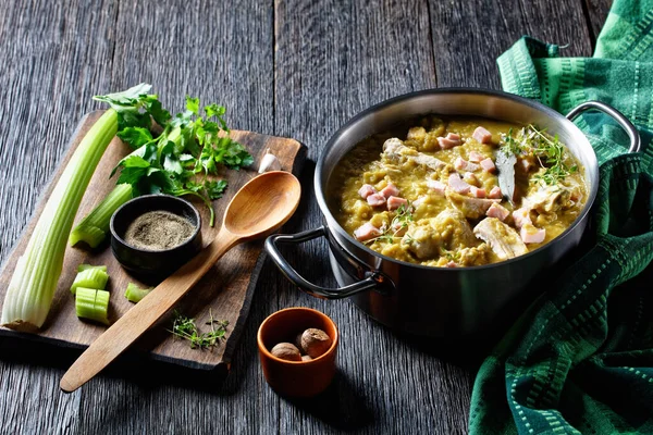 Green peas finnish soup with pork ribs and ham in a pot, horizontal view from above — Stock Image Green Peas Finnish Soup Pork Ribs Ham Pot Horizontal View Stock Image