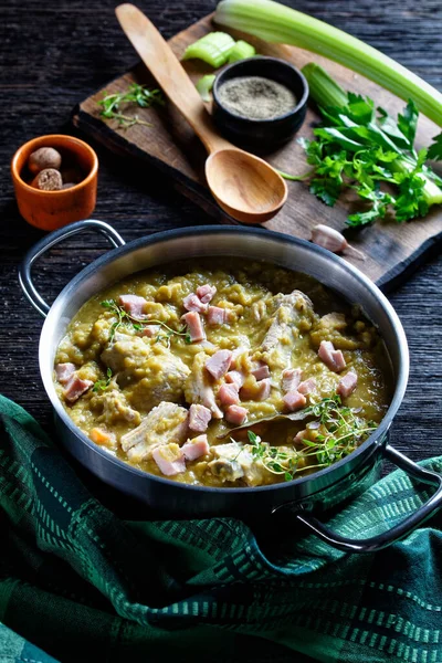 Green peas finnish soup with pork ribs and ham in a pot, vertical view from above — Stock Image Green Peas Finnish Soup Pork Ribs Ham Pot Vertical View Royalty Free Stock Images