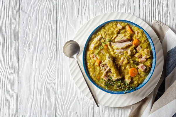 Green peas finnish soup with pork ribs and ham in a bowl, horizontal view from above, flat lay, free space — Stock Image Green Peas Finnish Soup Pork Ribs Ham Bowl Horizontal View Royalty Free Stock Photos