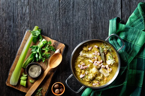 Green peas finnish soup with pork ribs and ham in a pot, horizontal view from above, free space — Stock Image Green Peas Finnish Soup Pork Ribs Ham Pot Horizontal View Royalty Free Stock Images