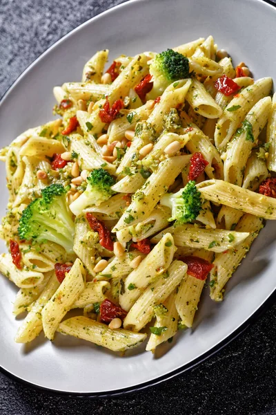 Close Broccoli Pesto Penne Pasta Sundried Tomatoes Pine Nuts Plate — Stock Photo, Image