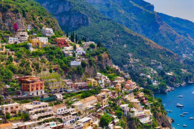 Positano 'nun Renkli Kayalık Köyü Amalfi Sahili' nde yemyeşil ve dramatik dağ zeminiyle Azure Akdeniz 'e dökülüyor.
