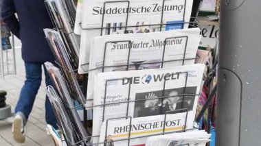 Alman gazetelerinin seçimi bir gazete bayiinin rafında sergilendi. Frankfurter Allgemeine, Die Welt ve Sueddeutsche Zeitung gibi büyük gazetelerden görünür manşetler.