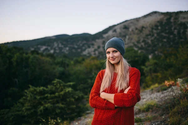 Portrait of a beautiful young blonde woman outdoor on the background of mountain and forest — Stock Photo, Image