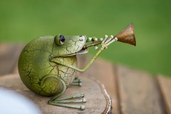 frog figurine with trumpet