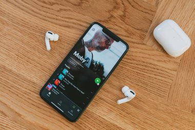 KAUNAS, LITHUANIA - 21 Kasım 2020: iPhone 11 Pro Spotify uygulaması ve Apple Airpod Pro kablosuz şarj çantası