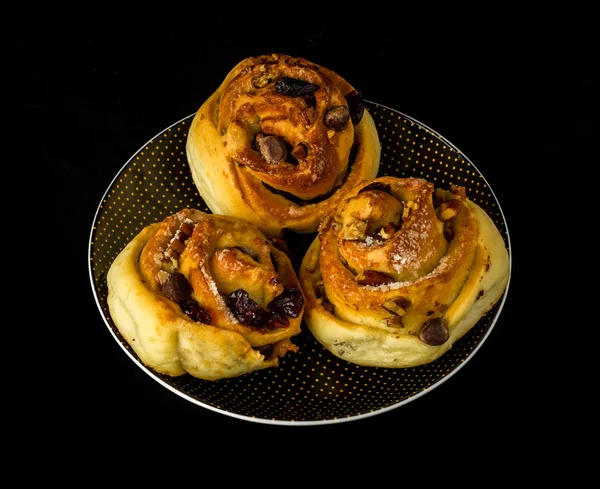 Nut rolls on a plate with black background — Stock Photo, Image
