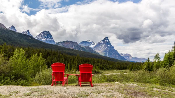 Canada Banff national park with chairs andfoggy mountains and forest.