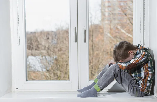 Kid sitting in window — Stock Photo, Image